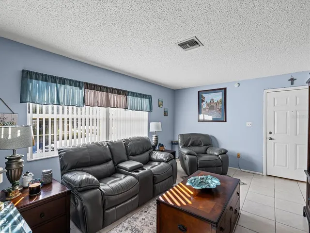 a living room with furniture a couch and a window