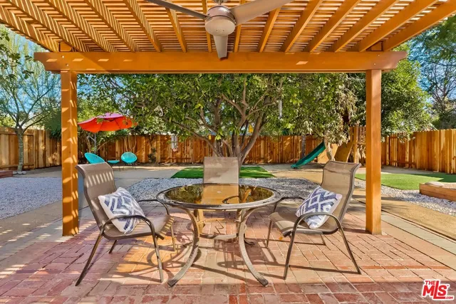 a patio with a yard table and chairs