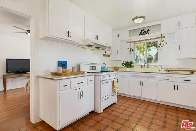 a kitchen with cabinets appliances and a sink