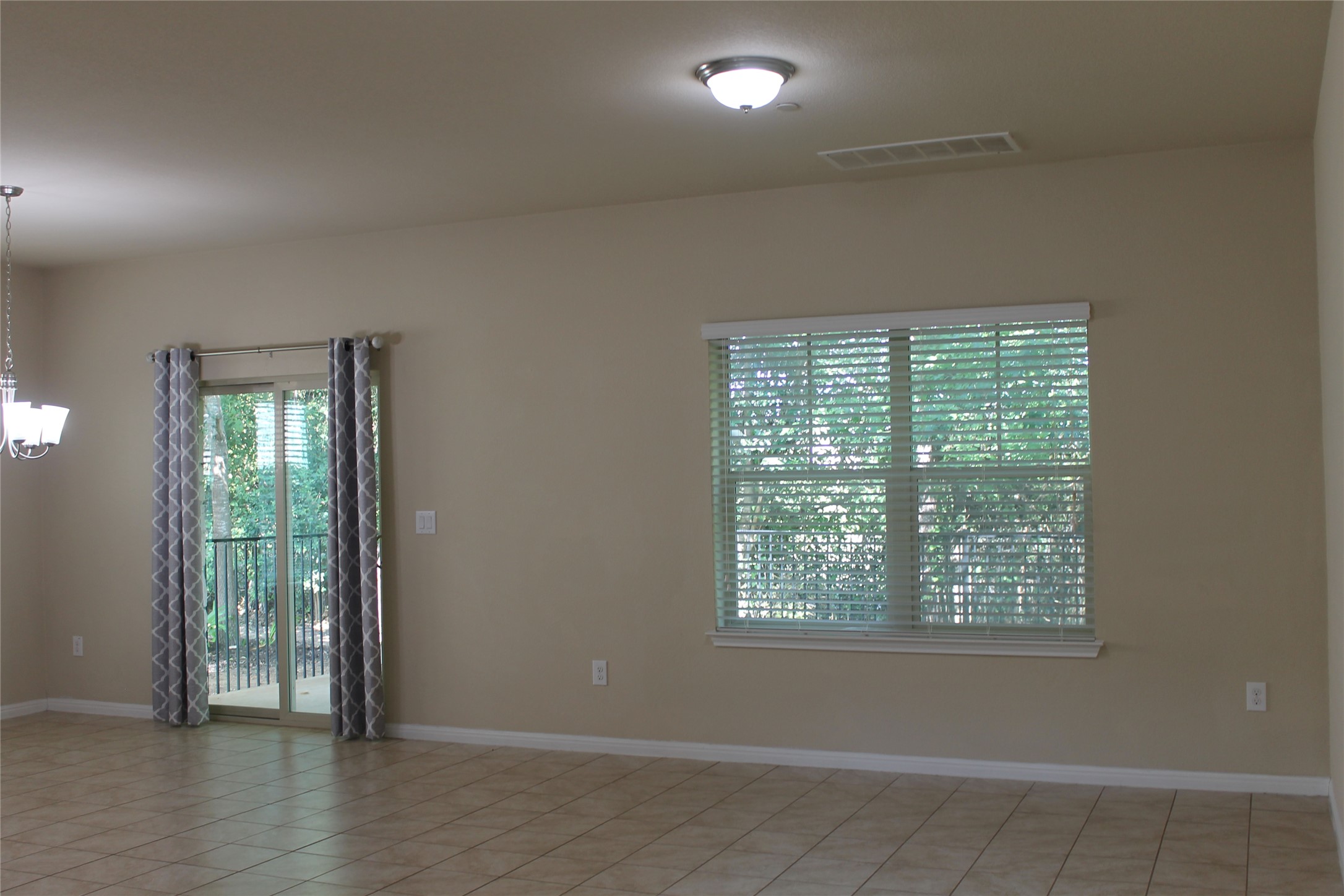 516 East Slaughter Lane, Unit 1801 Austin, TX 78744 - Photo 9 of 39 an empty room with wooden floor and windows