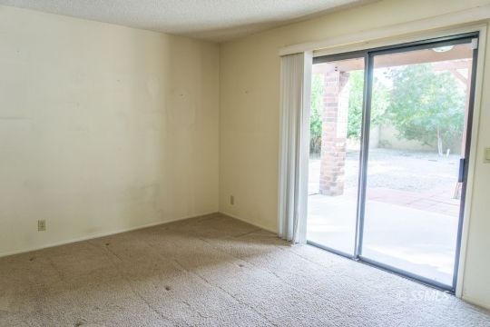 924 Scott Street Ridgecrest, CA 93555 - Photo 13 of 26 an empty room with sliding glass door