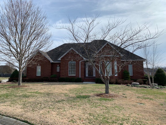 a front view of house with yard and trees