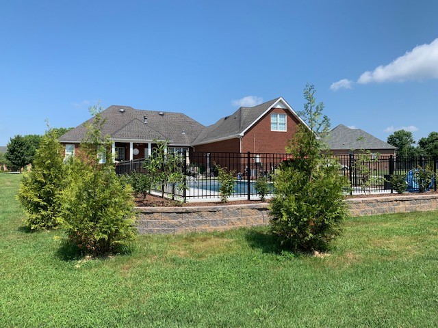 110 Hunters Point Tullahoma, TN 37388 - Photo 3 of 4 a front view of a house with a yard and garage