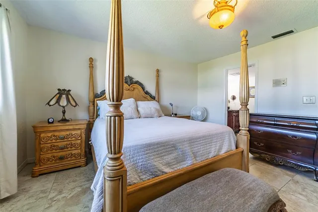 a bedroom with bed and wooden floor