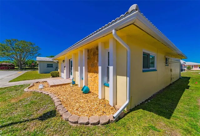 a view of house with backyard