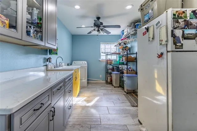 a kitchen with a refrigerator and a sink
