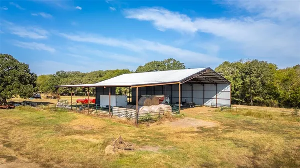 a view of a house with swimming pool and sitting area