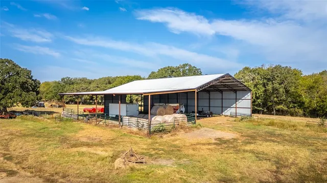 a view of a house with swimming pool and sitting area