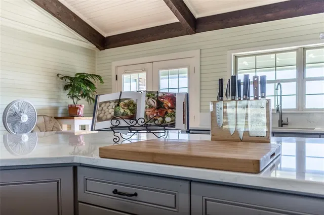 a kitchen with sink and wooden floor