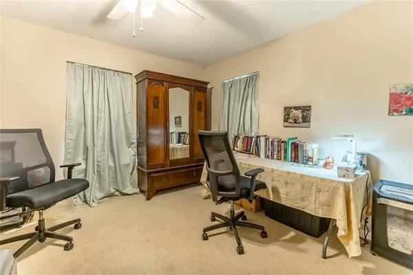 a view of a livingroom with workspace and a window