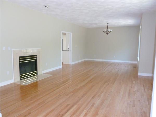 32 Townsend Farm Road Boxford, MA 01921 - Photo 14 of 25 a view of empty room with wooden floor and fireplace