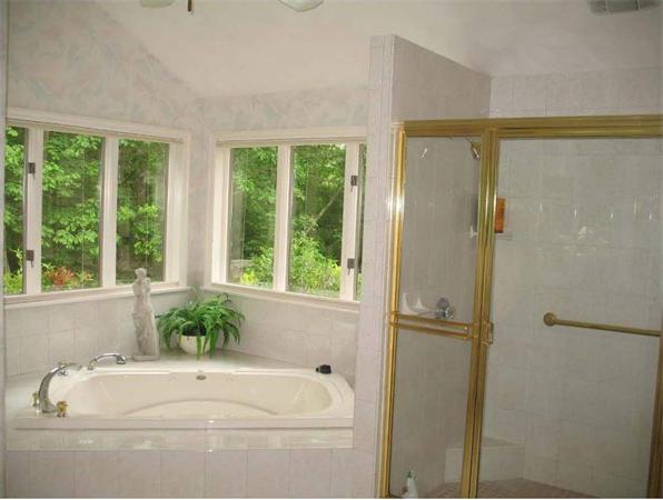 32 Townsend Farm Road Boxford, MA 01921 - Photo 17 of 25 a bathroom with a bathtub and window
