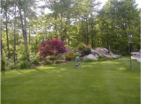 32 Townsend Farm Road Boxford, MA 01921 - Photo 22 of 25 a backyard of a house with lots of green space