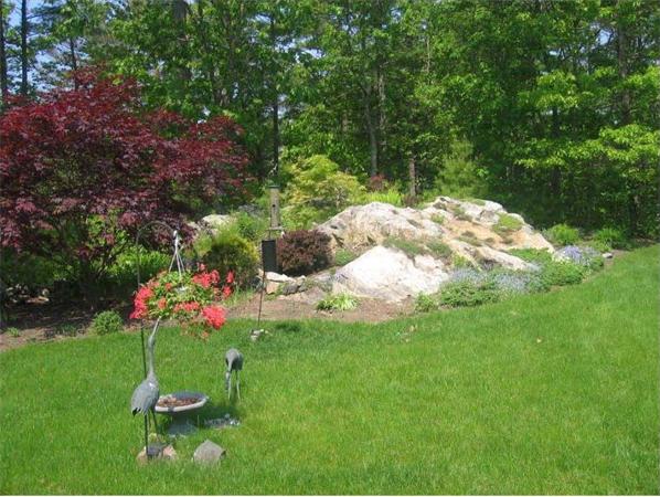 32 Townsend Farm Road Boxford, MA 01921 - Photo 23 of 25 a backyard of a house with a yard table and chairs