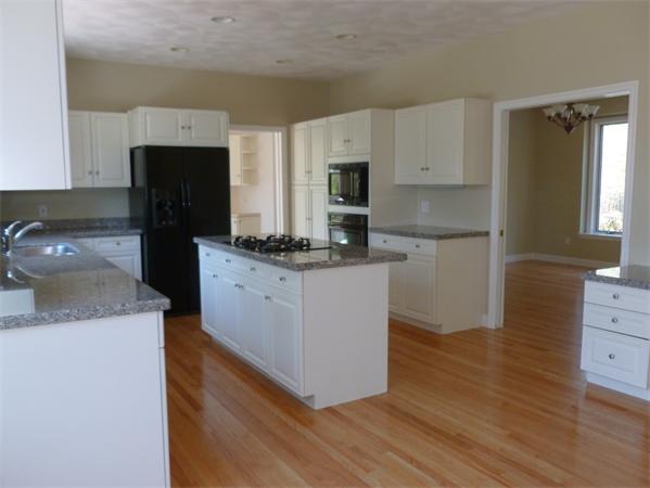 32 Townsend Farm Road Boxford, MA 01921 - Photo 3 of 25 a kitchen with kitchen island white cabinets and refrigerator