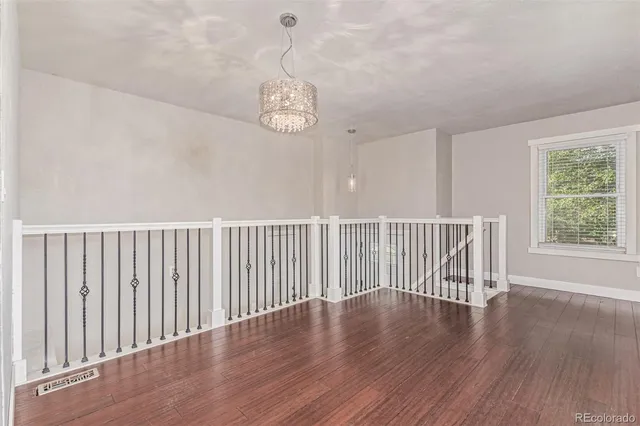 a view of a room with wooden floor and windows