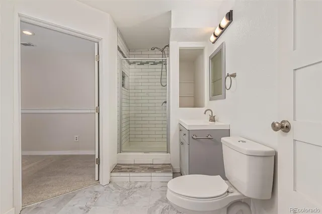 a bathroom with a toilet and a shower