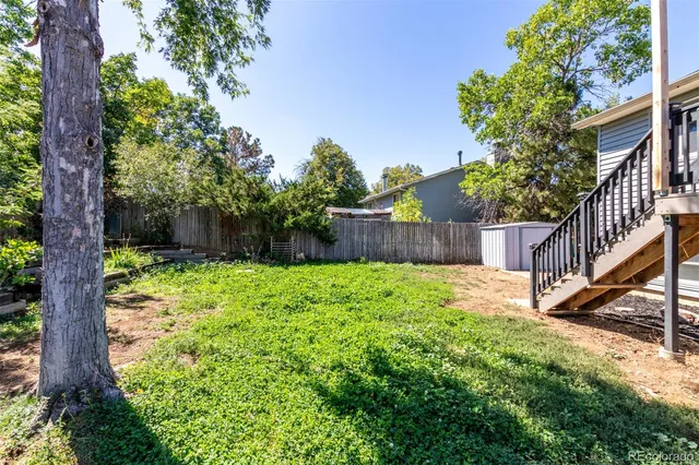 a view of a house with a yard and sitting area