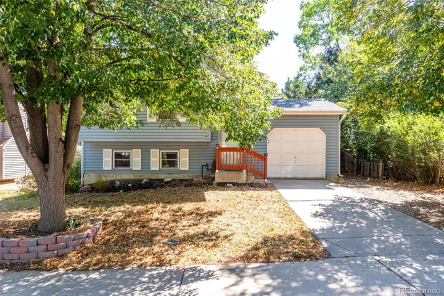 a backyard of a house with yard and outdoor seating