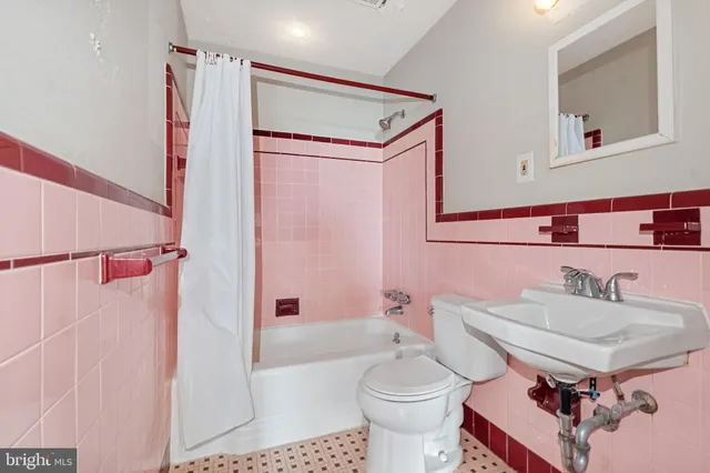 a view of an empty room with window and stairs