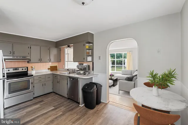 a kitchen with a refrigerator stove and sink