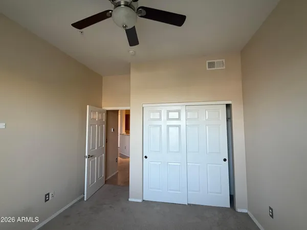 a view of room with window and ceiling fan