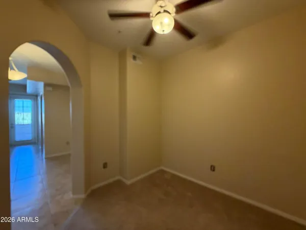 a view of room with window and ceiling fan