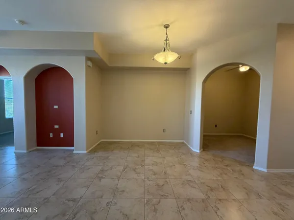 a view of a kitchen with a refrigerator and a chandelier