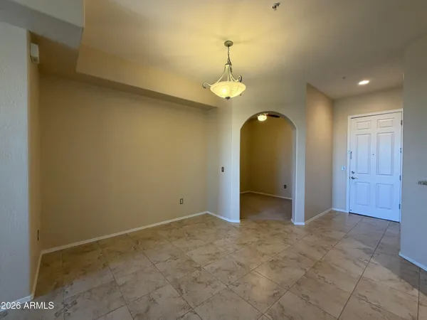 a view of a kitchen with a refrigerator and a chandelier