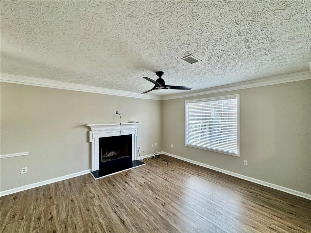 4922 Windsor Downs Lane Decatur, GA 30035 - Photo 12 of 23 wooden floor fireplace and windows in an empty room