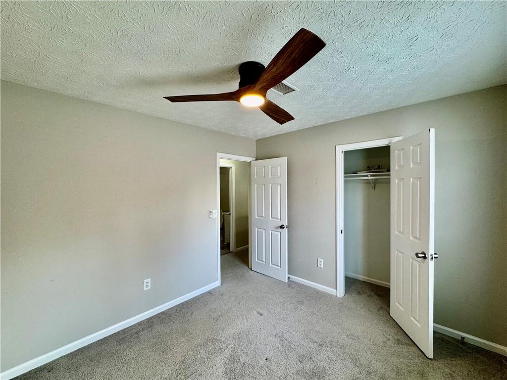 4922 Windsor Downs Lane Decatur, GA 30035 - Photo 15 of 23 a view of an empty room and chandelier fan
