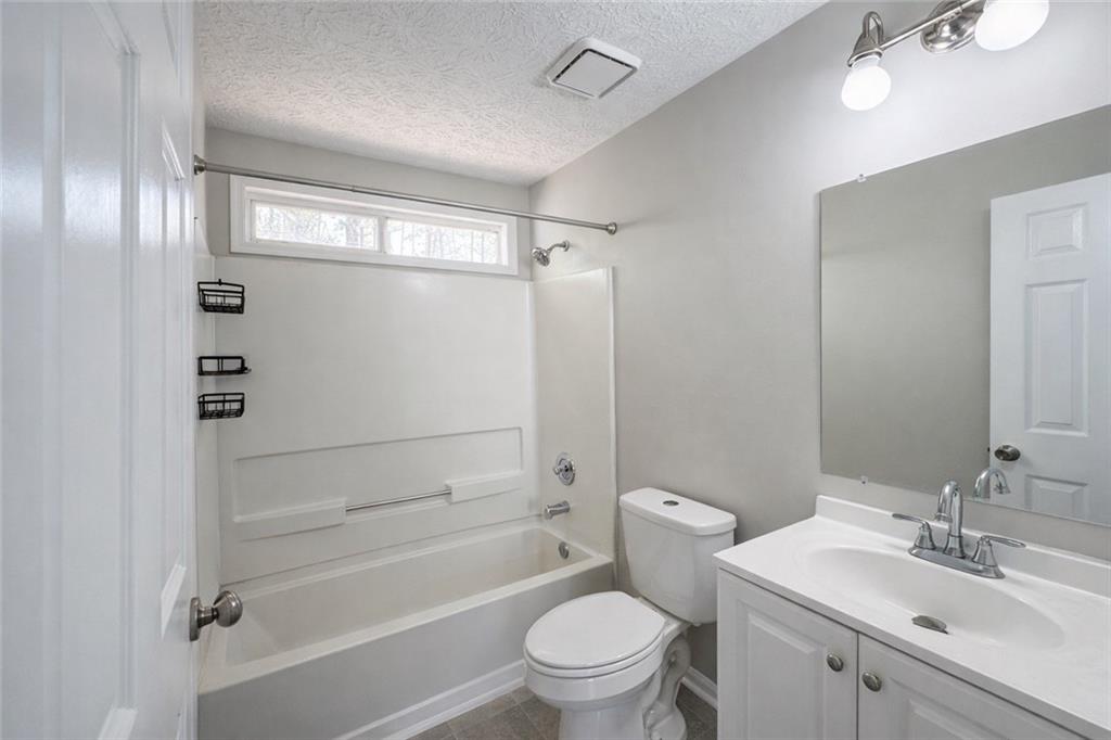 4922 Windsor Downs Lane Decatur, GA 30035 - Photo 16 of 23 a bathroom with a sink a toilet and shower
