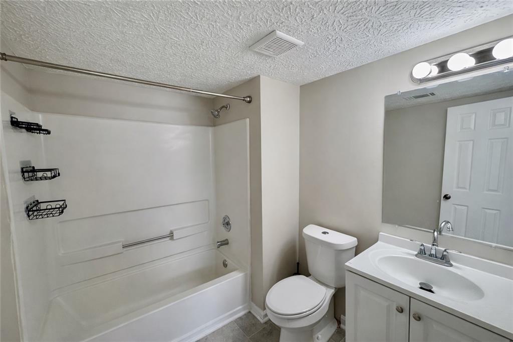 4922 Windsor Downs Lane Decatur, GA 30035 - Photo 20 of 23 a bathroom with a toilet a sink and shower