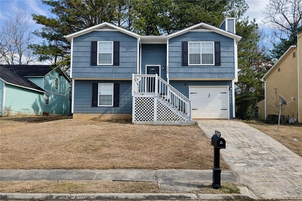 4922 Windsor Downs Lane Decatur, GA 30035 - Photo 2 of 23 a front view of a house with a yard and garage