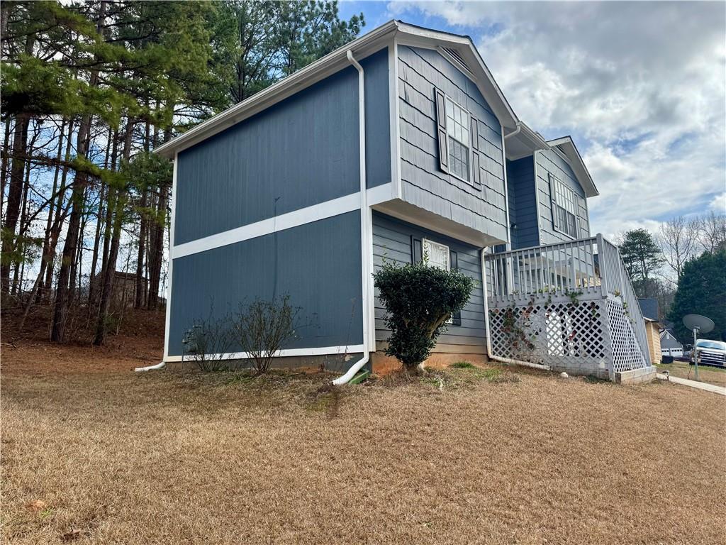 4922 Windsor Downs Lane Decatur, GA 30035 - Photo 3 of 23 a backyard of a house with barbeque oven and covered with trees