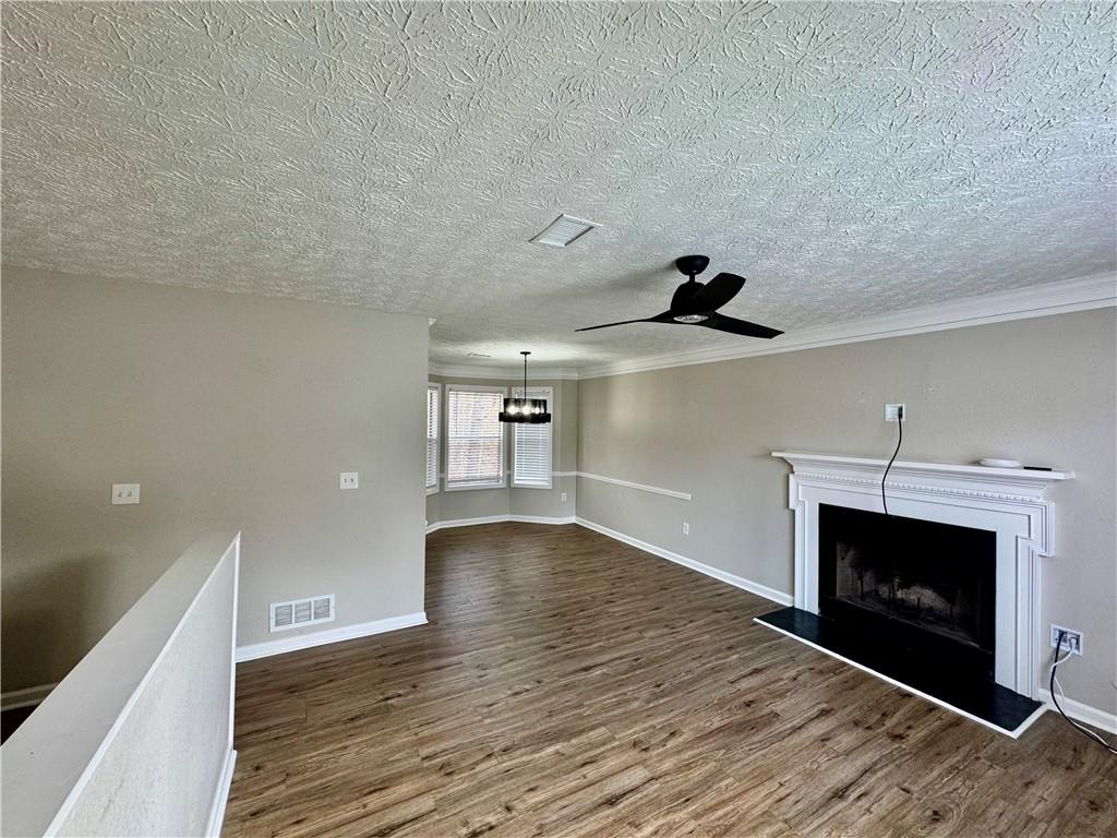 4922 Windsor Downs Lane Decatur, GA 30035 - Photo 6 of 23 a view of empty room with wooden floor and fireplace