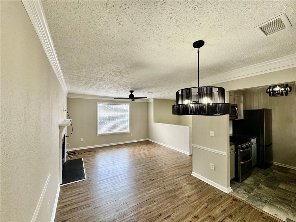 4922 Windsor Downs Lane Decatur, GA 30035 - Photo 8 of 23 a view of a room with wooden floor and kitchen space
