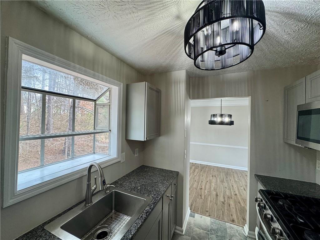 4922 Windsor Downs Lane Decatur, GA 30035 - Photo 10 of 23 a kitchen with a stove and cabinets