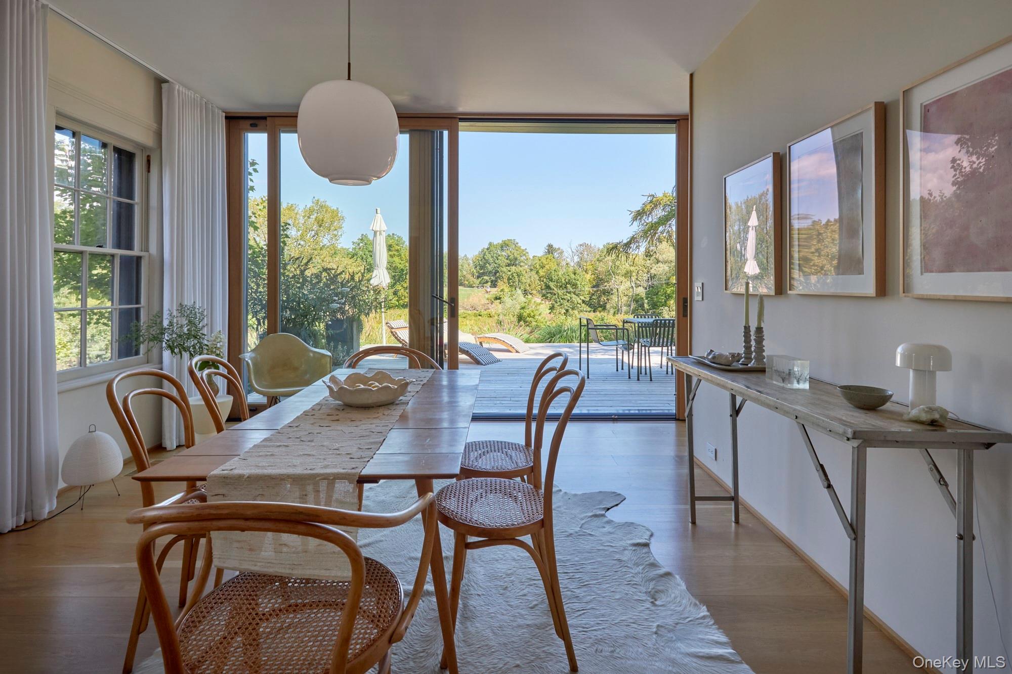 44 Main Street Germantown, NY 12526 - Photo 17 of 34 Dining space with wood finished floors, expansive windows, and view of wooded area