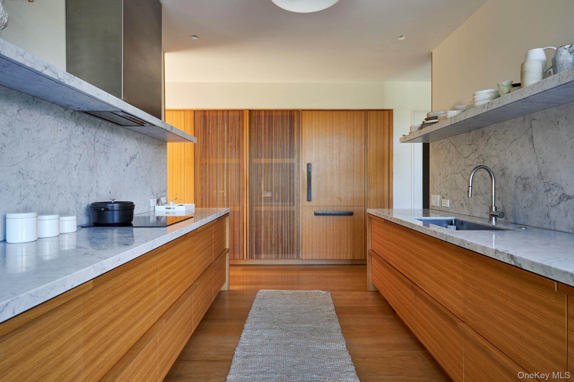 44 Main Street Germantown, NY 12526 - Photo 3 of 34 Kitchen with decorative backsplash, light stone counters, modern cabinets, and wall chimney range hood