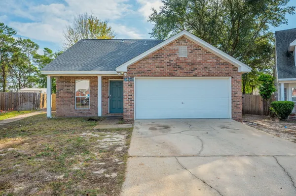 a view of a house with a yard and garage