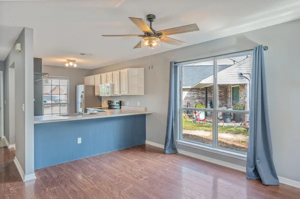 a workspace with a window and a kitchen