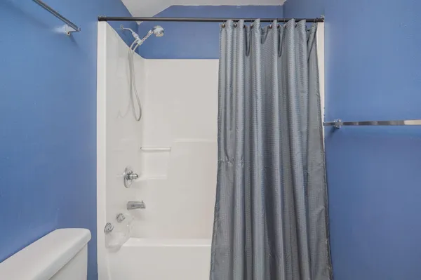 a bathroom with a shower and a tub