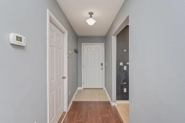 a view of a hallway with wooden floor