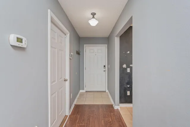 a view of a hallway with wooden floor