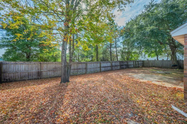 a view of small yard with wooden fence