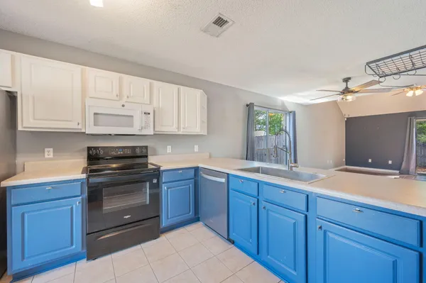 a kitchen with wooden cabinets and white appliances