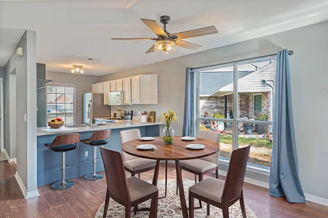 a view of a dining room with furniture window and wooden floor