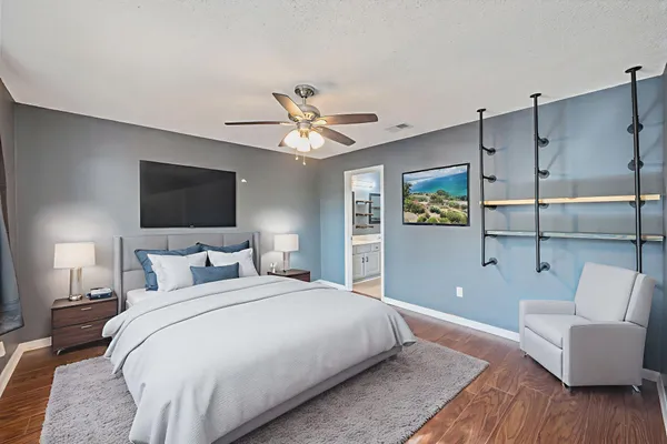 a bedroom with a bed couch and window