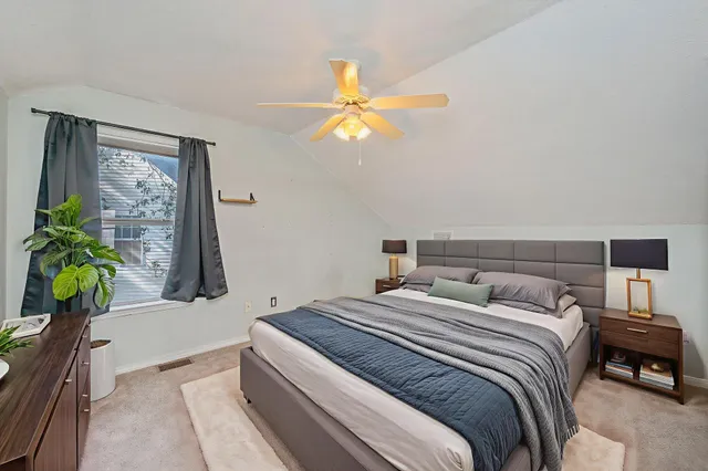 a bedroom with a bed and a chandelier